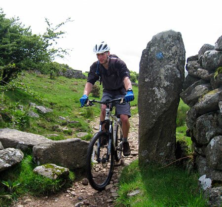 Guy on a mountain bike with helmet and blue gloves on the moor